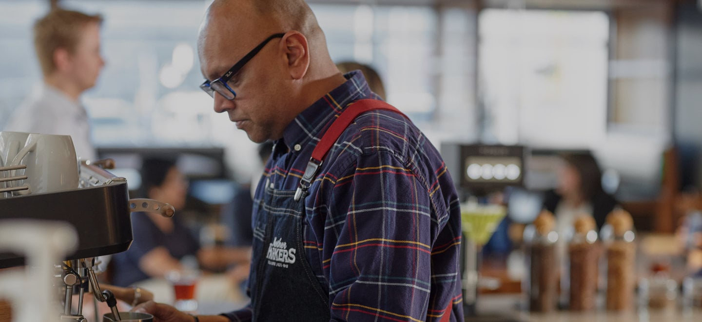 Barista creating a specialty coffee using an espresso machine