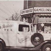 Vintage black and white shot of Mother Parkers' delivery vehicle delivering to a store