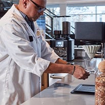 A technician using the barista space to test coffee