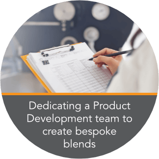 Person using a check list on a clipboard to assess tea in the factory